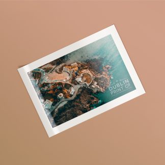 An A5 glossy laminated postcard with a photographic print of the Dublin coast.